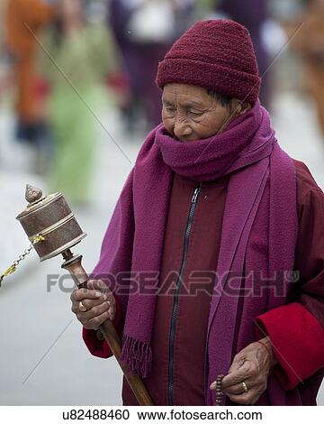 Woman spinning a prayer wheel, National Memorial Chorten, Thimphu, Bhutan View Large Photo Image Stock Image - Woman spinning a prayer wheel, National Memorial Chorten, Thimphu, Bhutan. Fotosearch