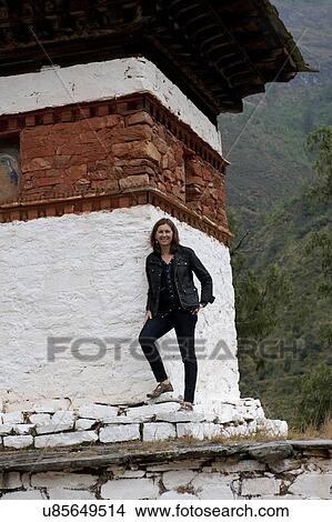 Woman standing at Tamchhog Lhakhang, Paro Valley, Paro District, Bhutan View Large Photo Image Picture - Woman standing at Tamchhog Lhakhang, Paro Valley, Paro District, Bhutan. Fotosearch