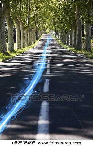 Blue streak of light on country road along trees View Large Photo Image Stock Photography - Blue streak of light on country road along trees. Fotosearch