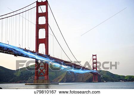 Stock Photo - Blue streak of light passing by Golden Gate Bridge against clear sky. Fotosearch