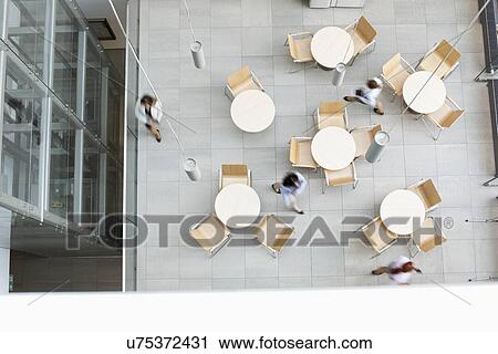 Blurred motion of businesswomen walking at office canteen View Large Photo Image Stock Image - Blurred motion of businesswomen walking at office canteen. Fotosearch