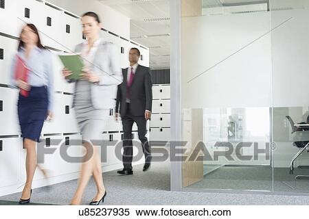Blurred view of businesswomen walking in office View Large Photo Image Stock Photography - Blurred view of businesswomen walking in office. Fotosearch