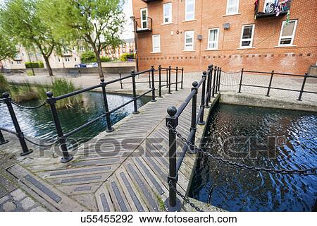 Stock Image - Bridge over canal against building. Fotosearch