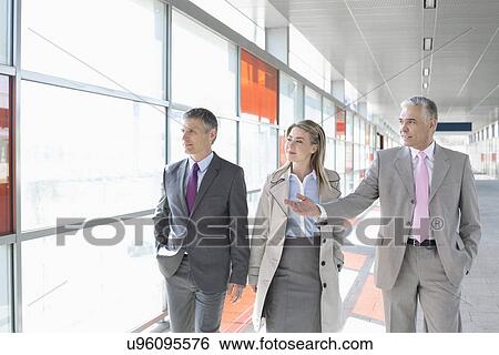 Business colleagues walking on train platform View Large Photo Image Stock Photograph - Business colleagues walking on train platform. Fotosearch