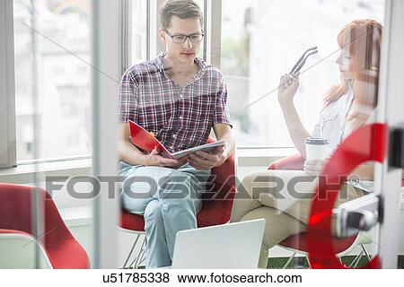 Business colleagues working in creative office View Large Photo Image Stock Photo - Business colleagues working in creative office. Fotosearch