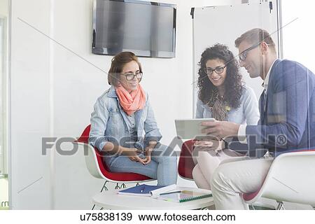 Business people discussing in meeting room View Large Photo Image Stock Photo - Business people discussing in meeting room. Fotosearch