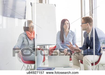 Business people discussing in meeting room View Large Photo Image Stock Photo - Business people discussing in meeting room. Fotosearch