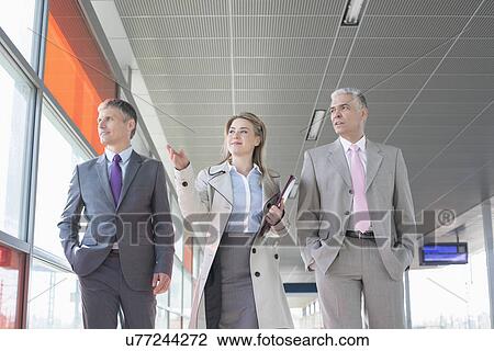 Business people discussing while walking on train platform View Large Photo Image Stock Image - Business people discussing while walking on train platform. Fotosearch