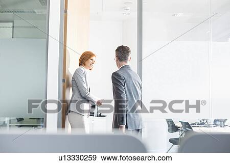 Stock Photo - Business people entering into conference room. Fotosearch