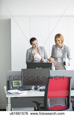 Business people having lunch while using computer in office View Large Photo Image Stock Photograph - Business people having lunch while using computer in office. Fotosearch