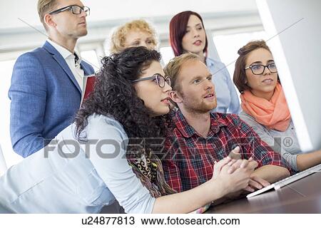 Business people using computer in office View Large Photo Image Stock Image - Business people using computer in office. Fotosearch