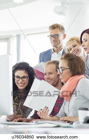 Business people using computer in creative office View Large Photo Image Stock Image - Business people using computer in creative office. Fotosearch