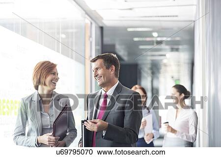 Business people walking in corridor View Large Photo Image Stock Image - Business people walking in corridor. Fotosearch
