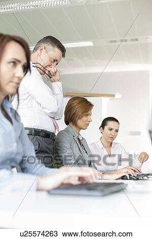 Business people working in office View Large Photo Image Stock Image - Business people working in office. Fotosearch