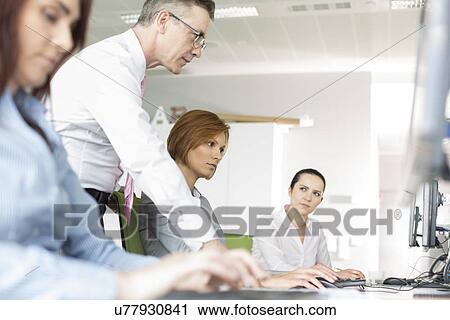Stock Image - Business people working in office. Fotosearch