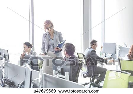 Business people working in open plan office View Large Photo Image Stock Photo - Business people working in open plan office. Fotosearch