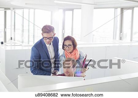 Business people working on computer in creative office View Large Photo Image Stock Image - Business people working on computer in creative office. Fotosearch