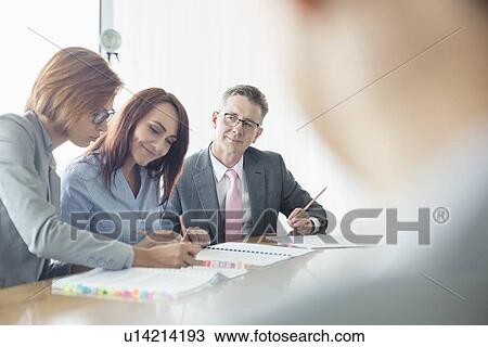 Business people working together at conference table View Large Photo Image Stock Image - Business people working together at conference table. Fotosearch