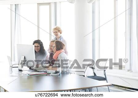 Picture - Business people working together in office. Fotosearch