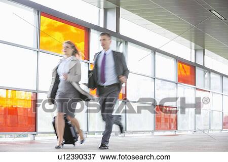 Businessman and businesswoman rushing in railroad station View Large Photo Image Stock Photo - Businessman and businesswoman rushing in railroad station. Fotosearch