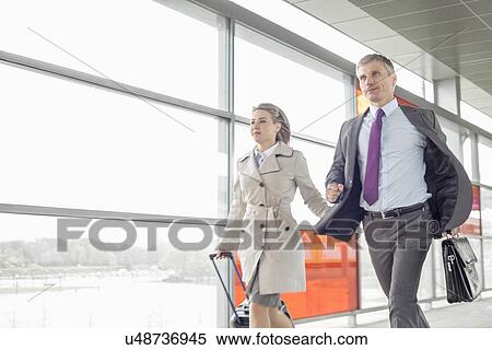 Businessman and businesswoman rushing in railroad station View Large Photo Image Stock Photography - Businessman and businesswoman rushing in railroad station. Fotosearch