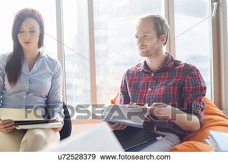 Businessman and businesswoman working in office View Large Photo Image Stock Photo - Businessman and businesswoman working in office. Fotosearch
