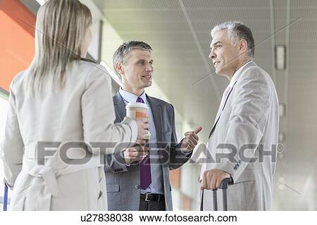 Businesspeople communicating on railroad platform View Large Photo Image Stock Photo - Businesspeople communicating on railroad platform. Fotosearch