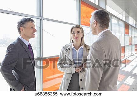 Businesspeople communicating on train platform View Large Photo Image Stock Photography - Businesspeople communicating on train platform. Fotosearch