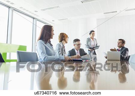 Businesspeople in a meeting View Large Photo Image Stock Photograph - Businesspeople in a meeting. Fotosearch