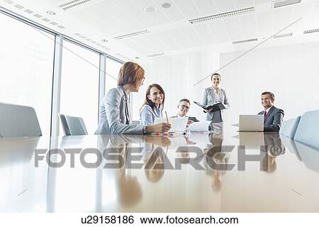 Businesspeople in conference room View Large Photo Image Stock Photograph - Businesspeople in conference room. Fotosearch