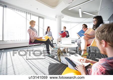 Businesspeople in meeting at office View Large Photo Image Stock Photo - Businesspeople in meeting at office. Fotosearch