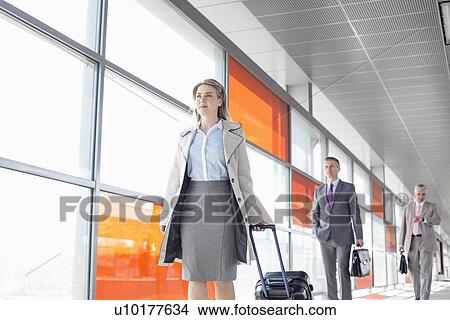 Businesspeople walking on train platform View Large Photo Image Picture - Businesspeople walking on train platform. Fotosearch