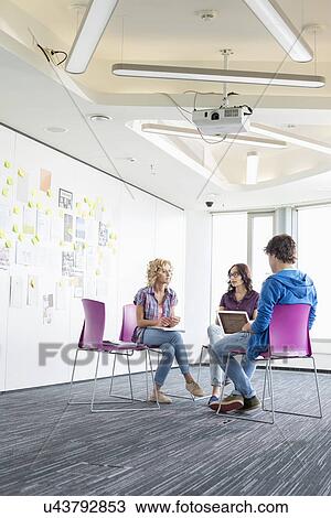 Businesspeople working at creative office space View Large Photo Image Stock Image - Businesspeople working at creative office space. Fotosearch