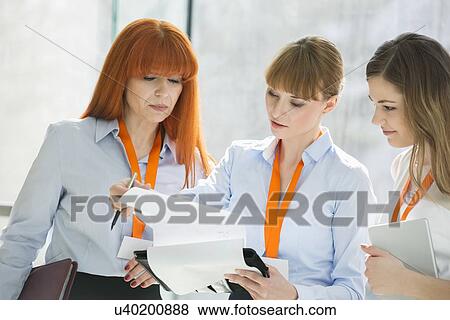 Businesswomen doing paperwork in office View Large Photo Image Stock Photo - Businesswomen doing paperwork in office. Fotosearch