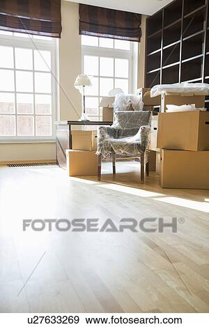 Cardboard boxes and furniture in new home View Large Photo Image Stock Photo - Cardboard boxes and furniture in new home. Fotosearch