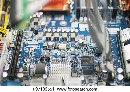 Stock Image - Close-up of computer circuit board in manufacturing industry. Fotosearch
