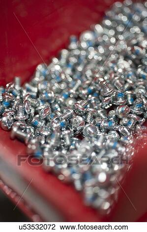 Close-up of screws in tray at manufacturing industry View Large Photo Image Stock Image - Close-up of screws in tray at manufacturing industry. Fotosearch
