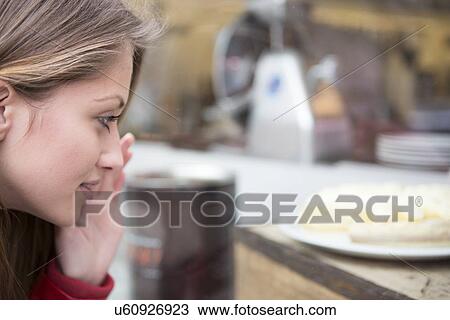 Close-up of woman looking at cake in cafe View Large Photo Image Stock Image - Close-up of woman looking at cake in cafe. Fotosearch