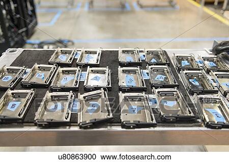 Stock Image - Computer parts arranged on table in manufacturing industry. Fotosearch