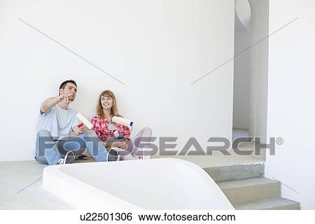Stock Photograph - Couple getting ready to paint. Fotosearch