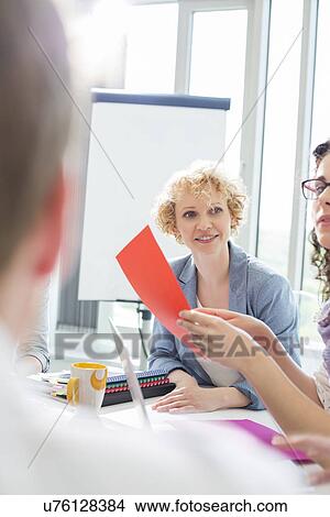 Creative businesswoman in meeting with colleagues at office View Large Photo Image Picture - Creative businesswoman in meeting with colleagues at office. Fotosearch