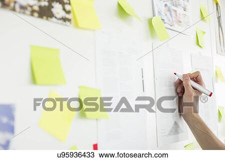 Cropped image of businessman's hand writing on paper in office View Large Photo Image Stock Image - Cropped image of businessman's hand writing on paper in office. Fotosearch