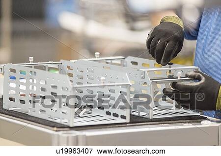 Cropped image of female engineer repairing computer part in manufacturing industry View Large Photo Image Stock Photo - Cropped image of female engineer repairing computer part in manufacturing industry. Fotosearch