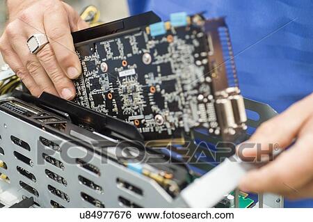 Cropped image of male engineer repairing video card in computer manufacturing industry View Large Photo Image Stock Photograph - Cropped image of male engineer repairing video card in computer manufacturing industry. Fotosearch