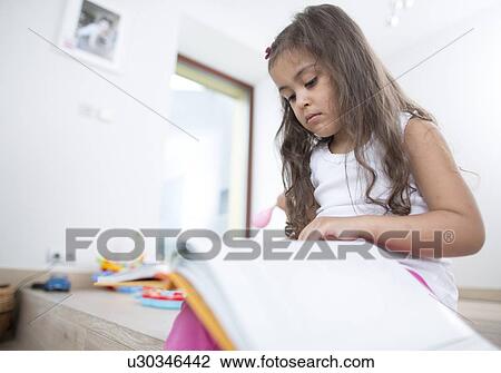 Cute girl reading book at home View Large Photo Image Stock Image - Cute girl reading book at home. Fotosearch