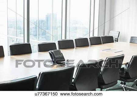 Stock Image - Empty conference room with telephone. Fotosearch
