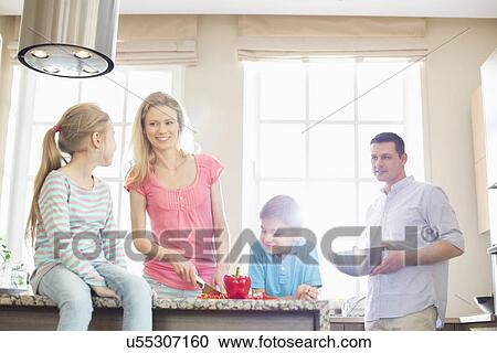 Family preparing food in kitchen View Large Photo Image Stock Image - Family preparing food in kitchen. Fotosearch