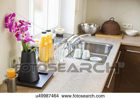 Flower vase with juice bottles on kitchen counter View Large Photo Image Picture - Flower vase with juice bottles on kitchen counter. Fotosearch