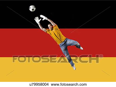 Football Goalkeeper saving shot in front of German National Flag View Large Photo Image Picture - Football Goalkeeper saving shot in front of German National Flag. Fotosearch