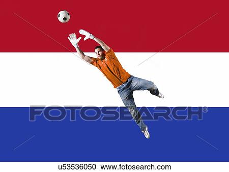 Football Goalkeeper saving shot in front of Dutch National Flag View Large Photo Image Stock Image - Football Goalkeeper saving shot in front of Dutch National Flag. Fotosearch